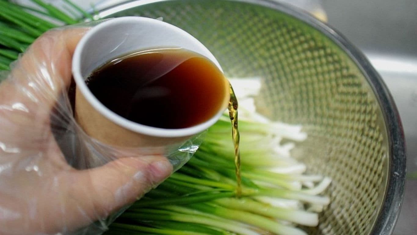 Pouring Sauce Over Fresh Green Onions