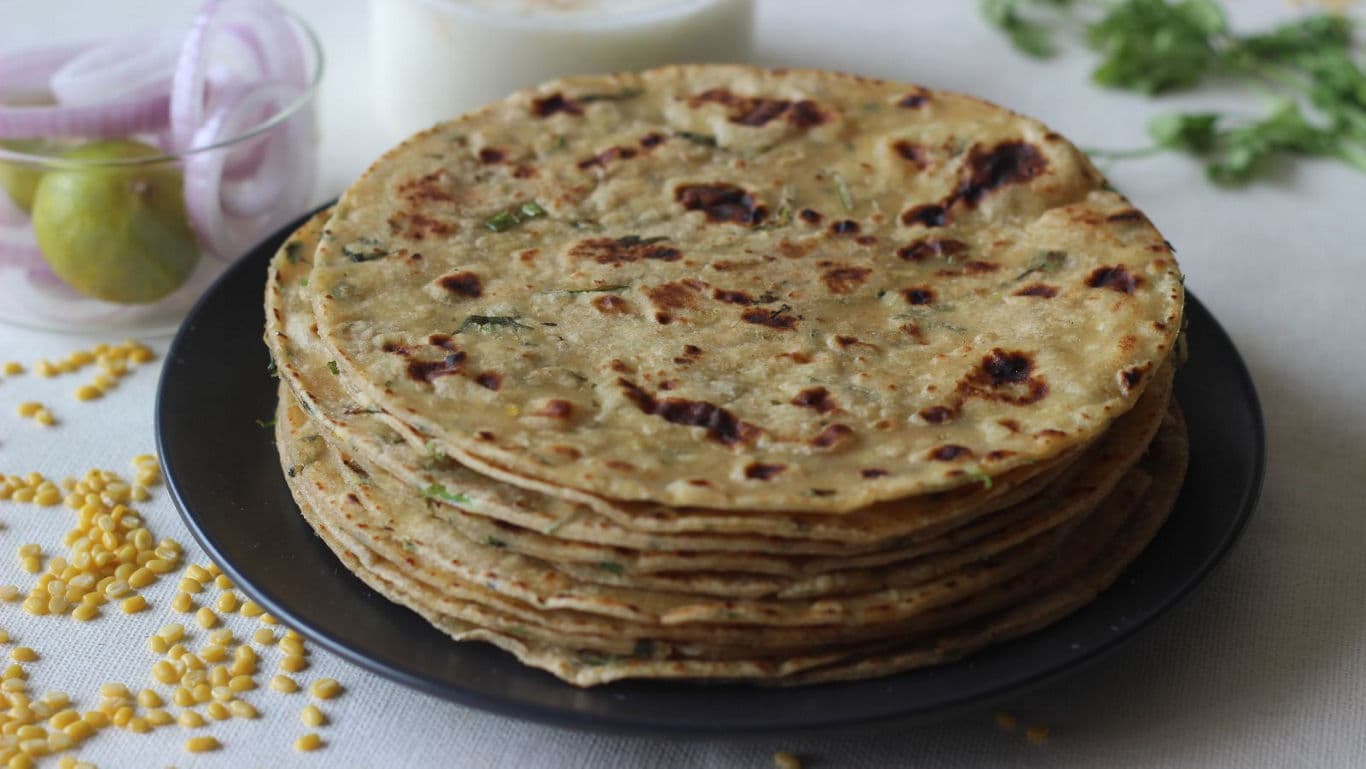 Stack of Indian flatbreads on black plate