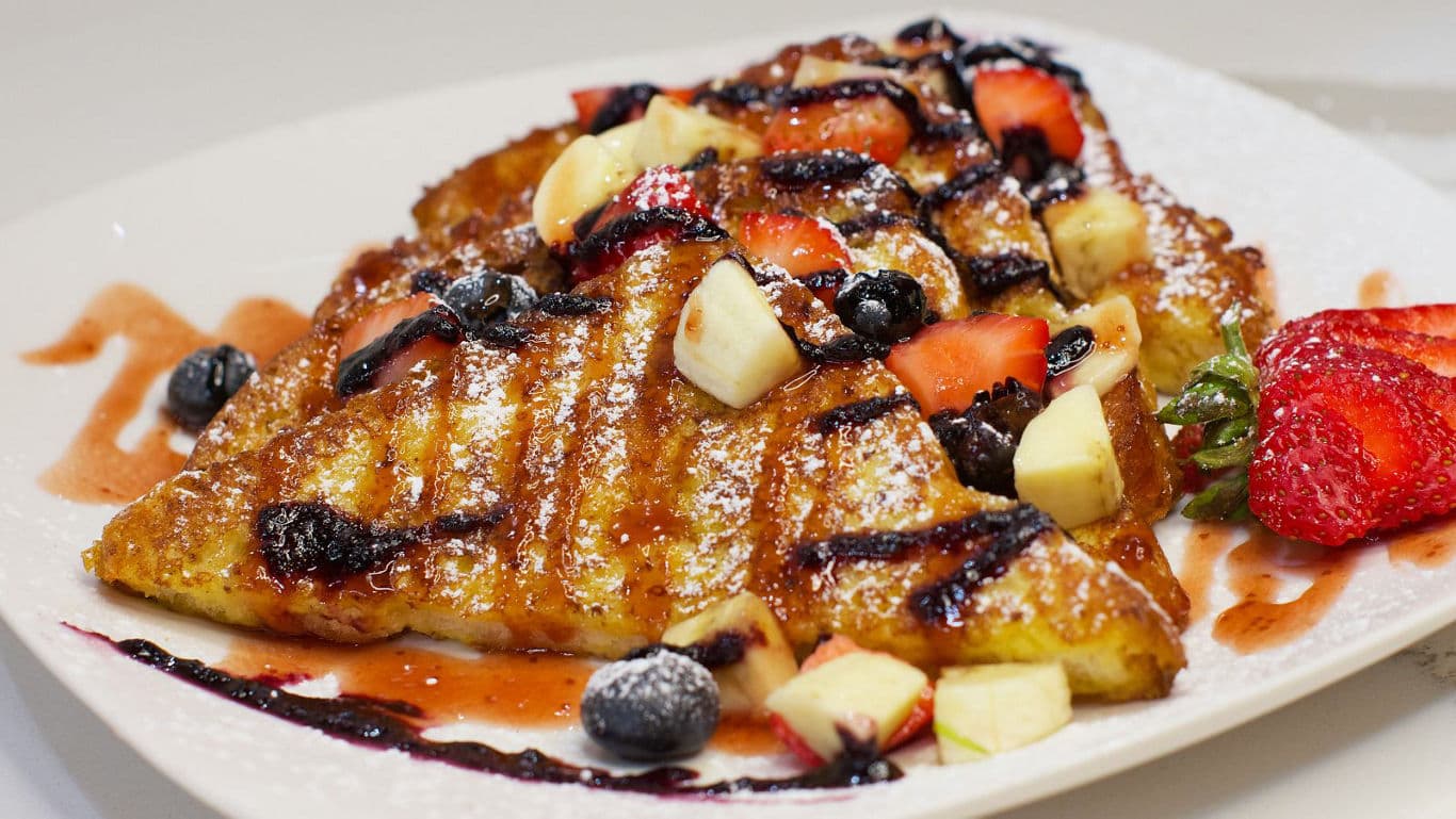 French toast with fresh berries and banana slices
