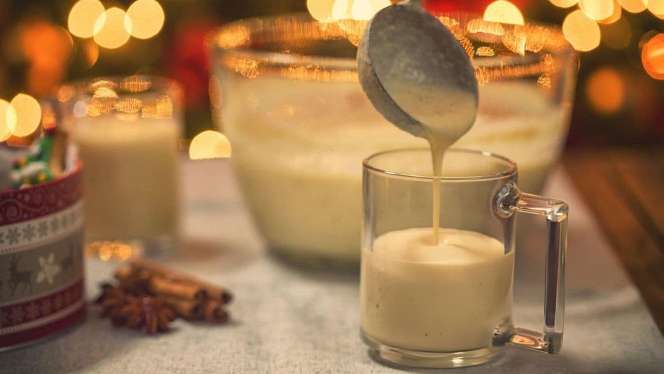Fresh eggnog poured into a glass.