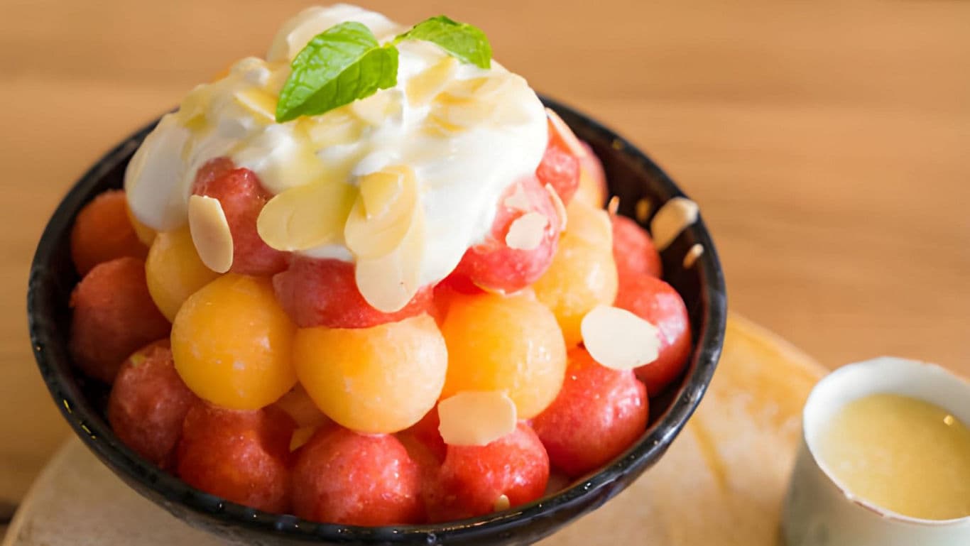 Fruit dessert with yogurt and almonds