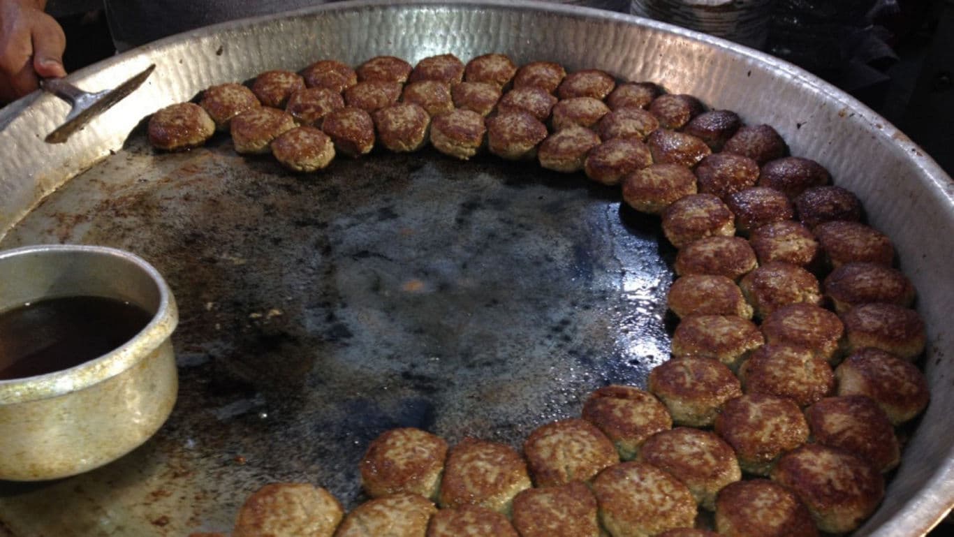 Large Tray of Kebabs Cooking on Griddle
