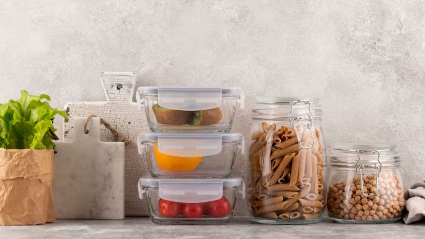 Glass food storage containers and jars on kitchen counter