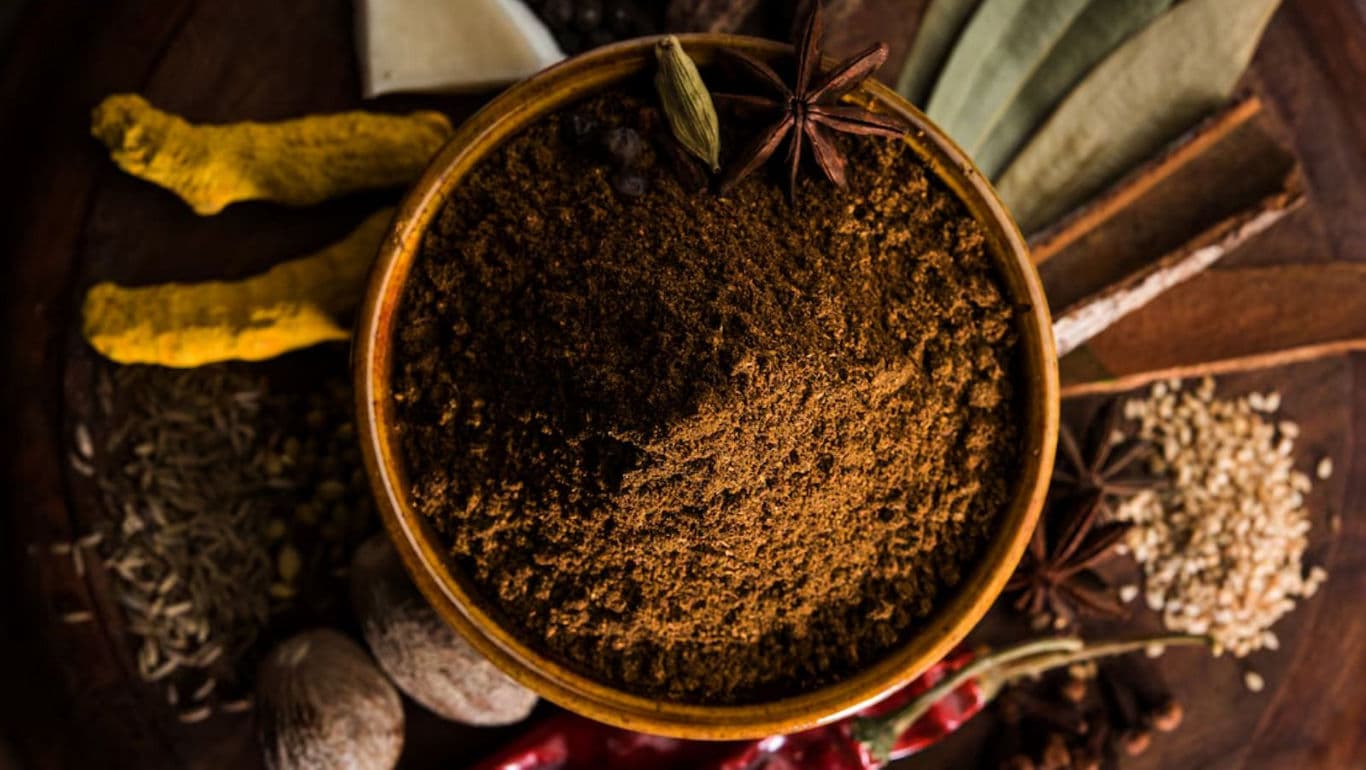 Bowl of Ground Spices with Whole Ingredients