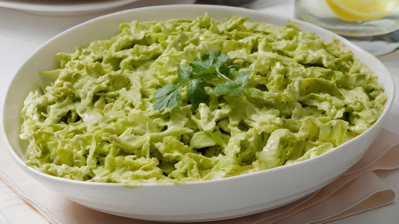 Creamy green salad in white bowl