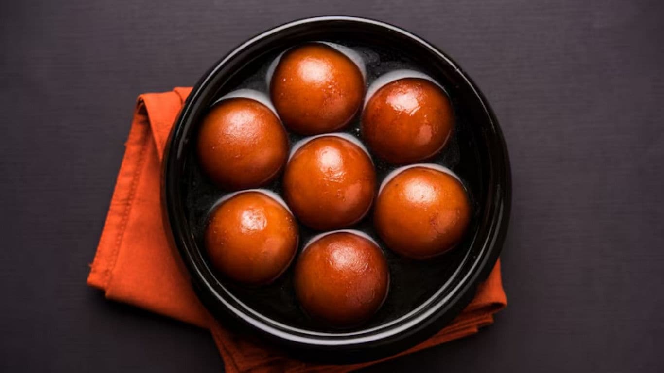 Traditional Indian Gulab Jamun Dessert in Black Bowl