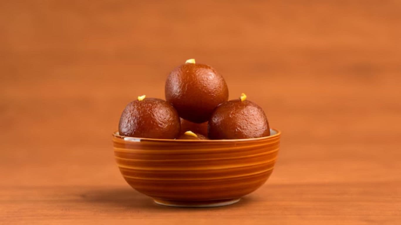 Bowl of Gulab Jamun on Wooden Surface