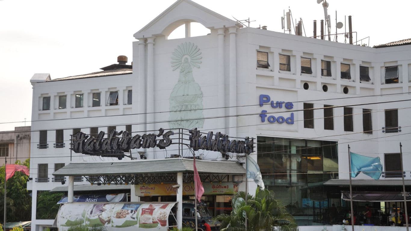 Large White Building with Pure Food Signage