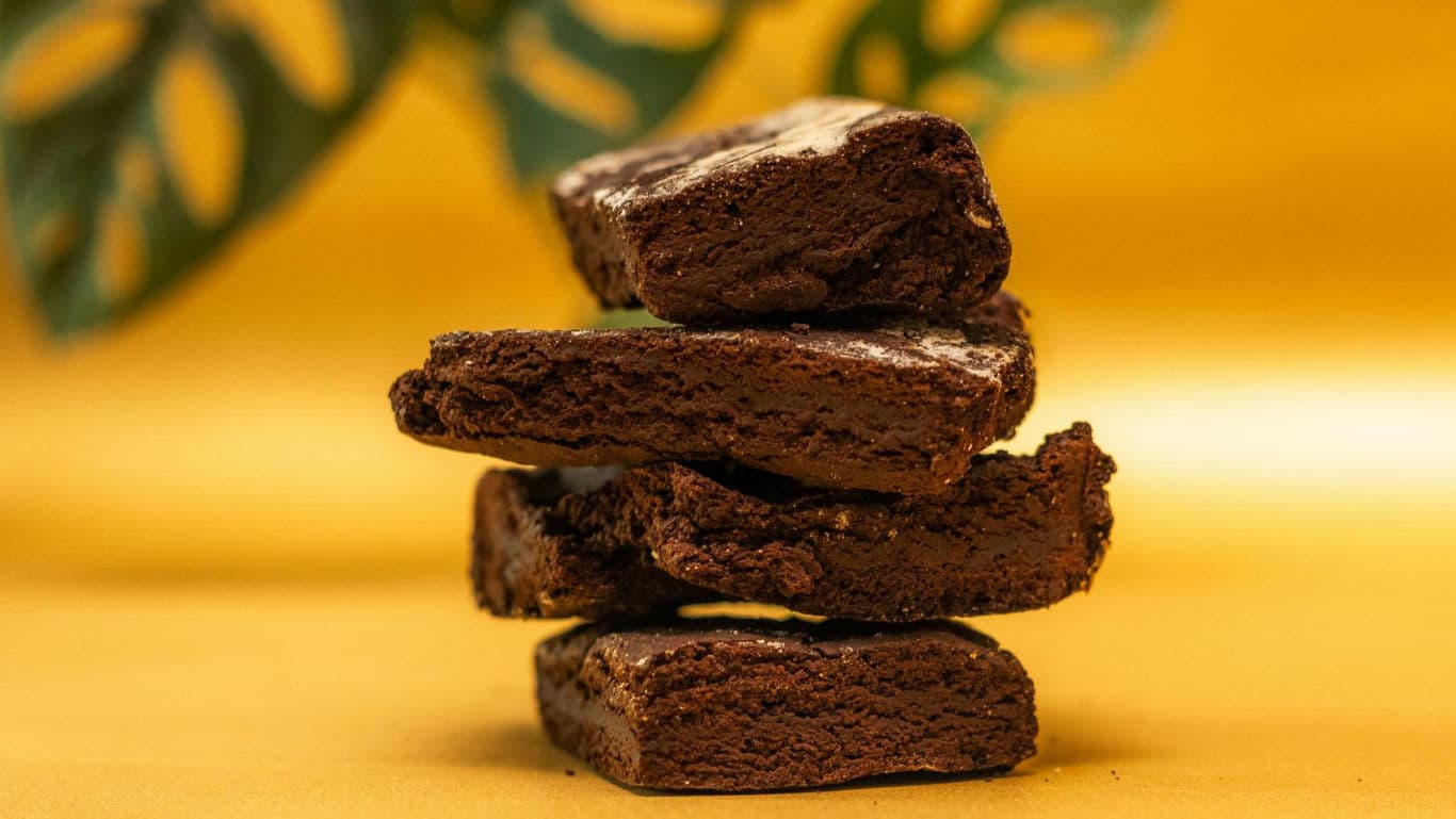 Stack of chocolate brownies on yellow background