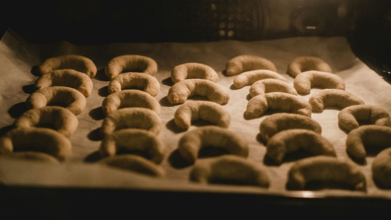 Baking crescent-shaped cookies in oven