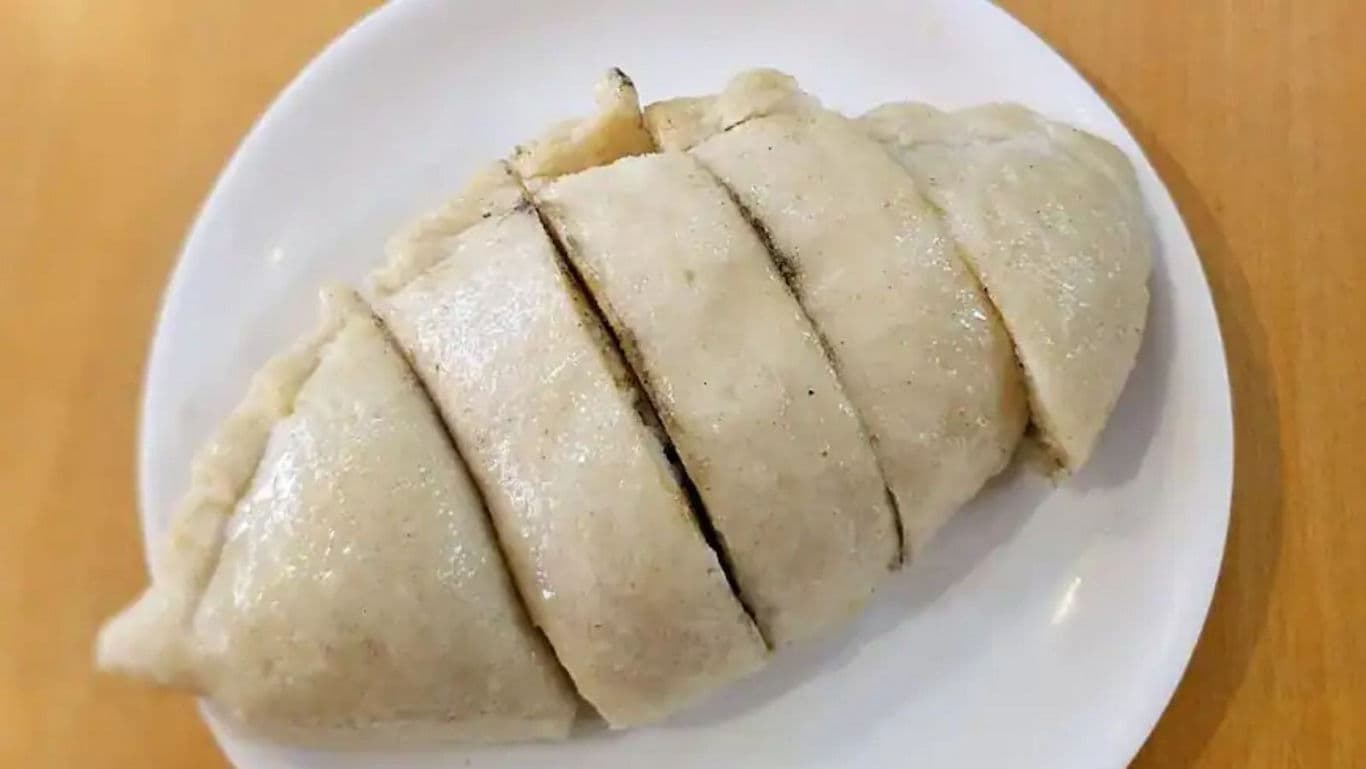 Sliced steamed dumpling on white plate