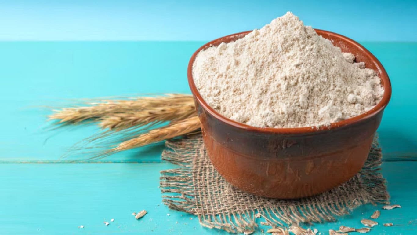 Rustic bowl of flour on blue table