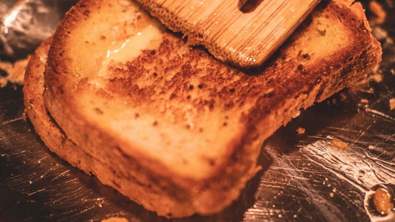 Golden buttered toast on hot griddle