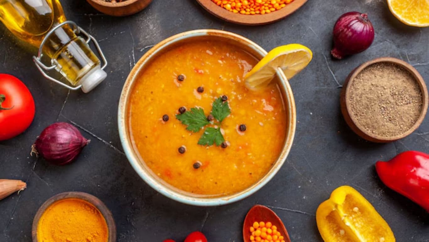 Bowl of lentil soup with fresh ingredients