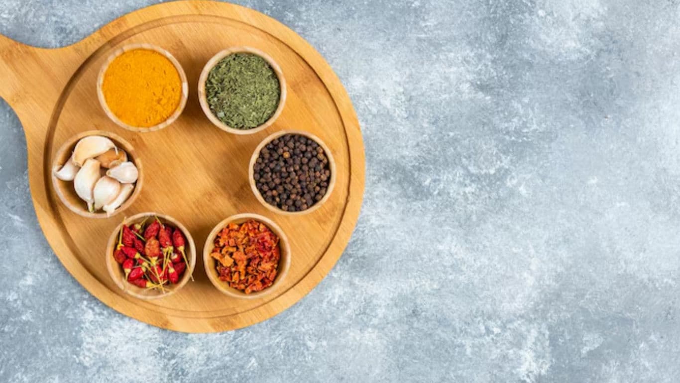 Assorted spices on wooden platter