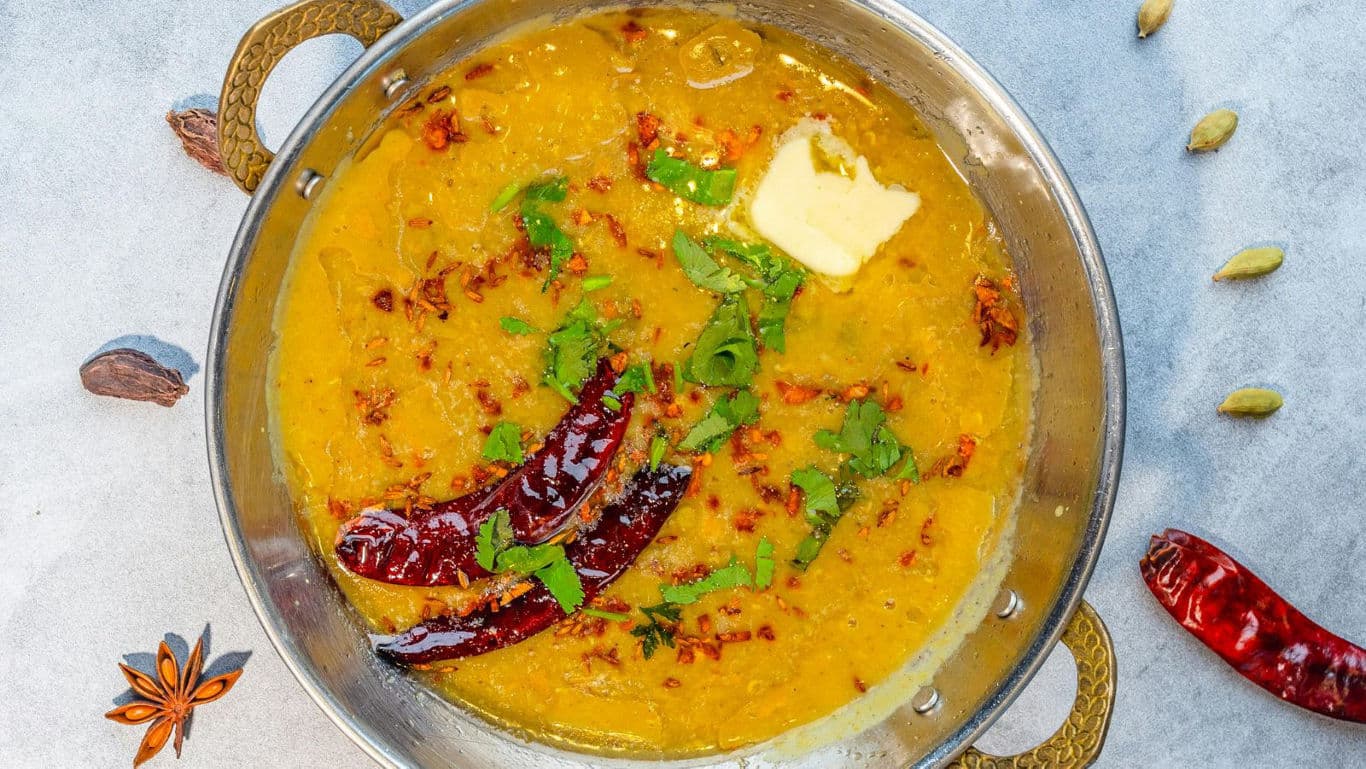 Spicy lentil curry with garnish in bowl