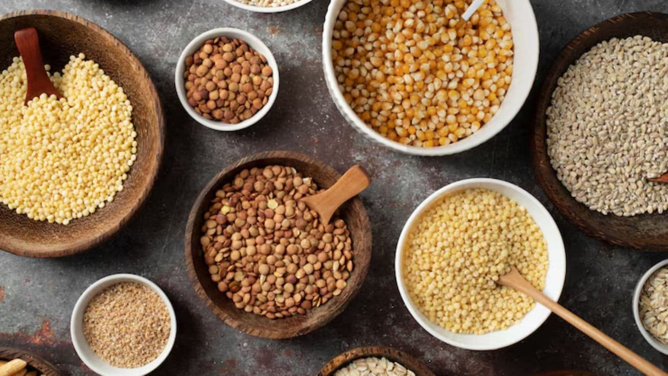 Assorted grains and legumes in rustic bowls overhead