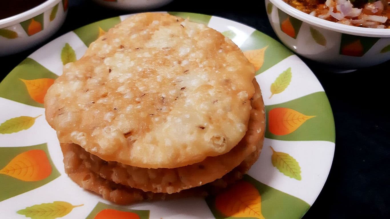 Stacked fried flatbreads on colorful plate