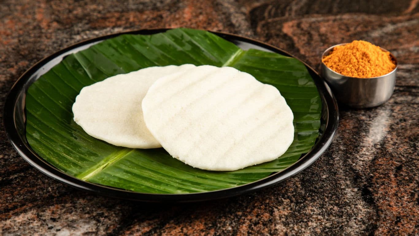 Traditional South Indian idlis on banana leaf plate