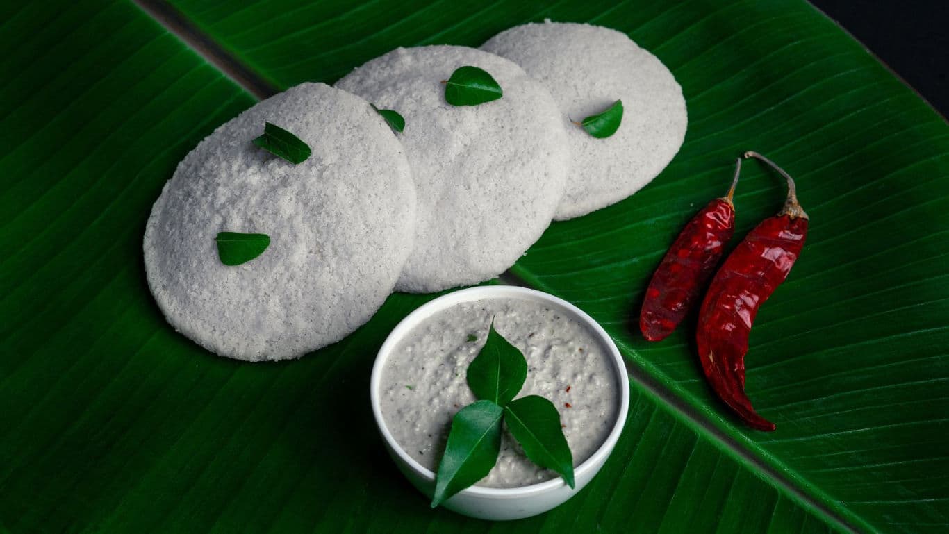 South Indian idli with chutney on banana leaf