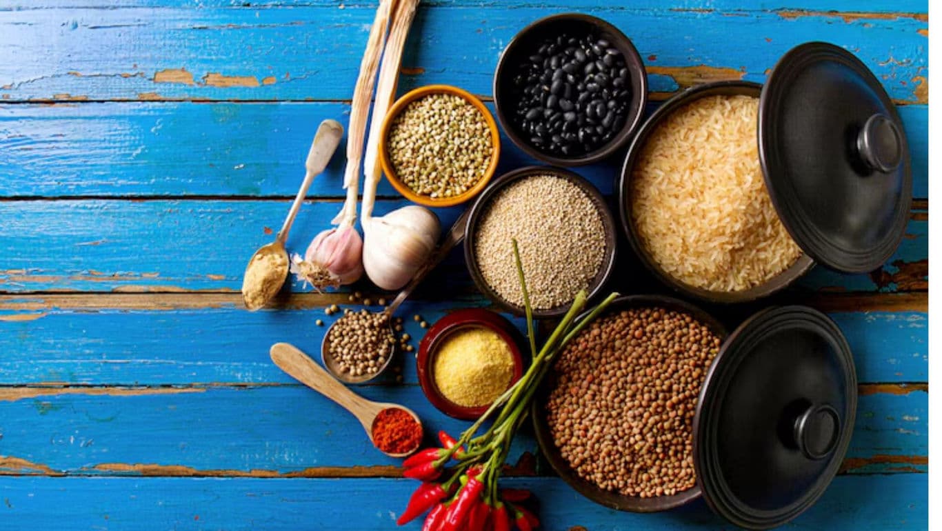 Assorted grains and spices on rustic table