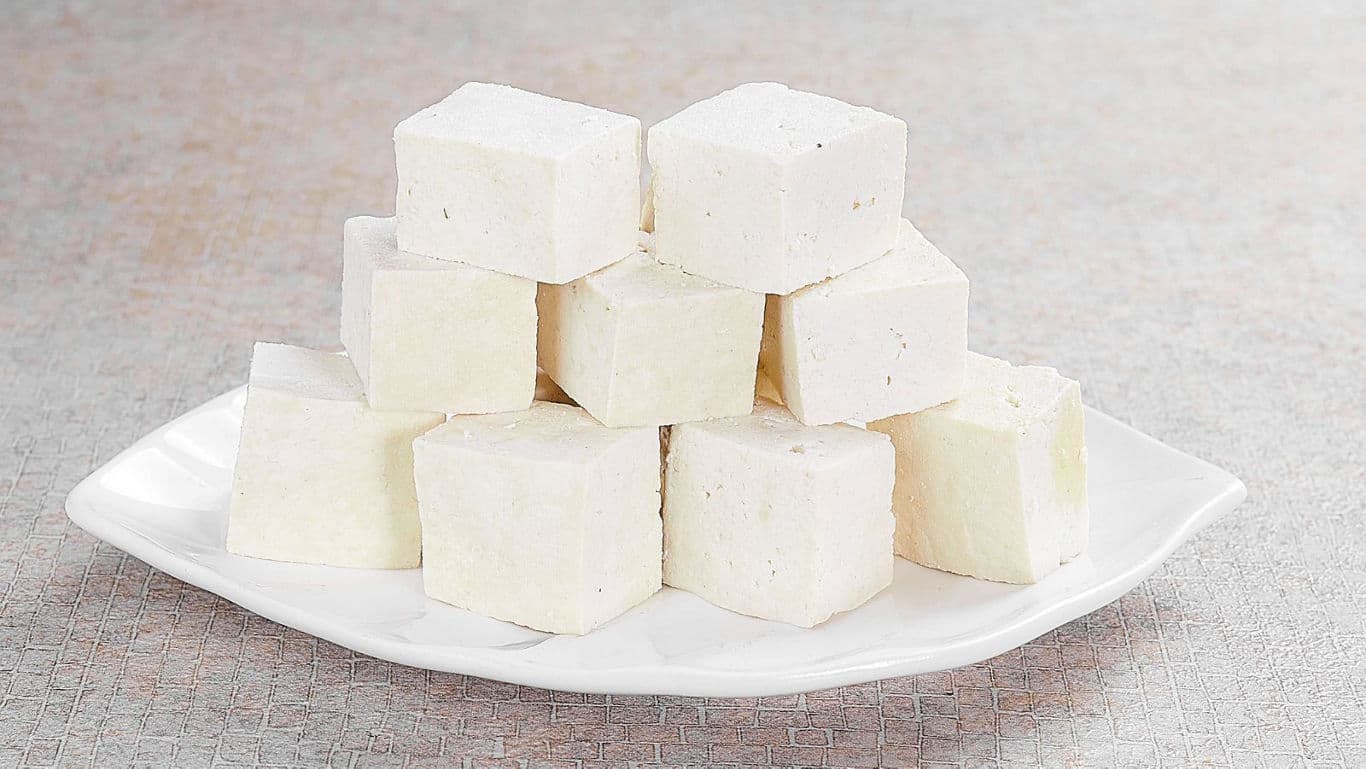 Stacked tofu cubes on white plate