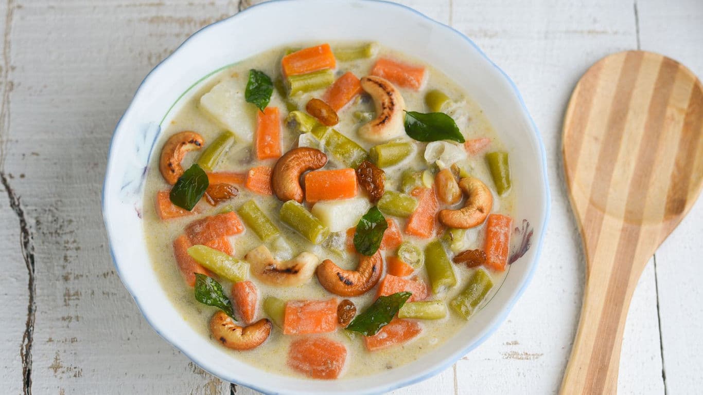 Vegetable stew with cashews in white bowl