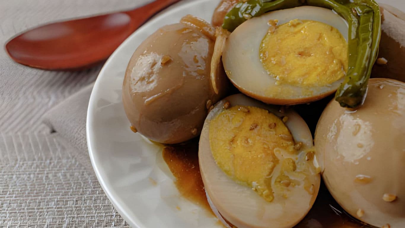 Soy-marinated eggs with green chili garnish