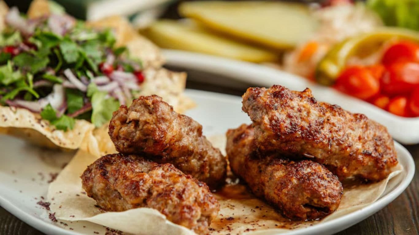 Grilled meat kebabs with fresh sides