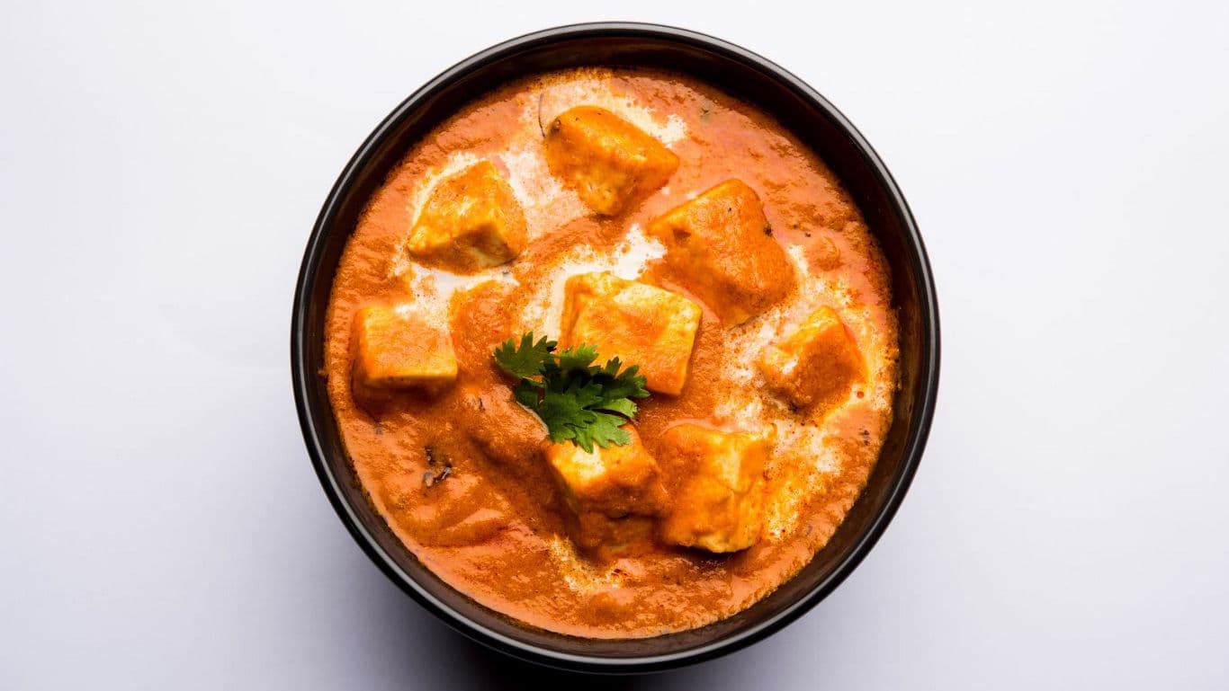 Creamy paneer curry in black bowl