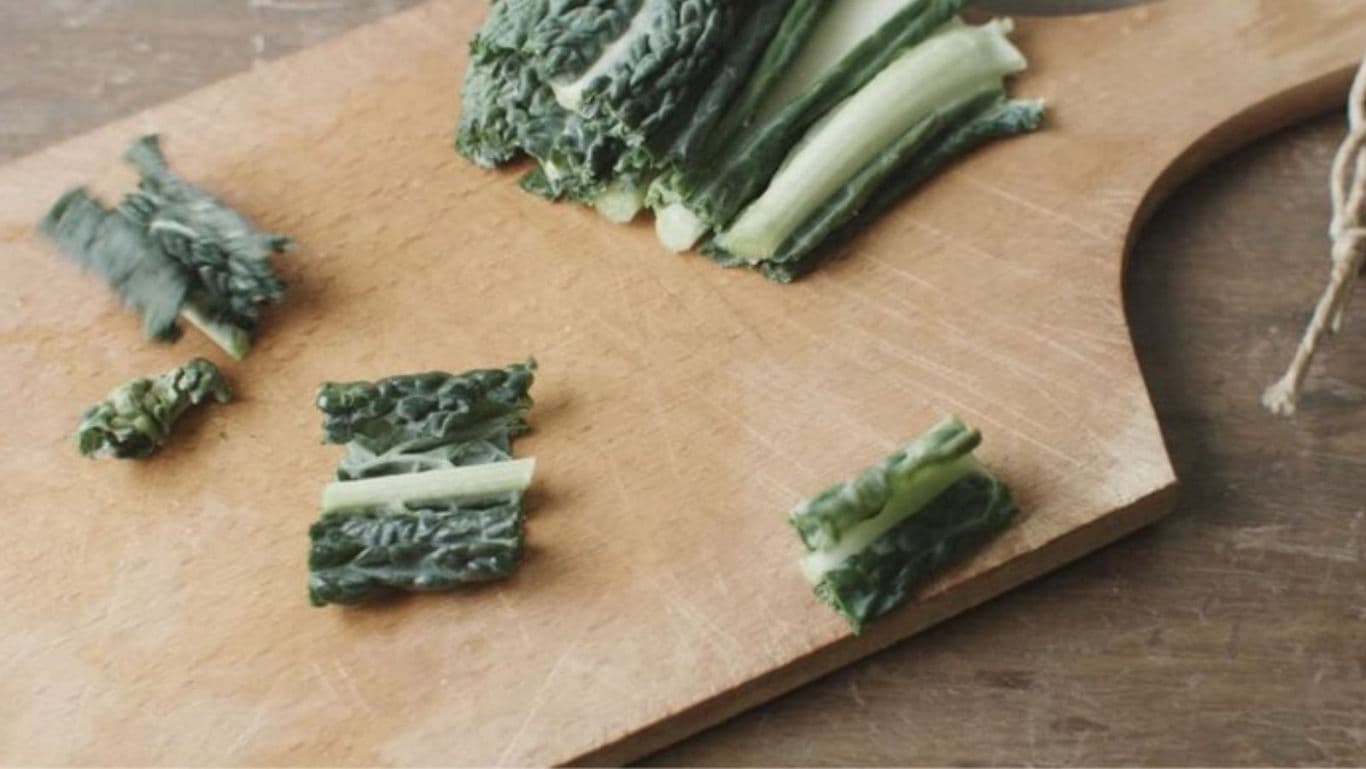 Chopped leafy greens on wooden cutting board