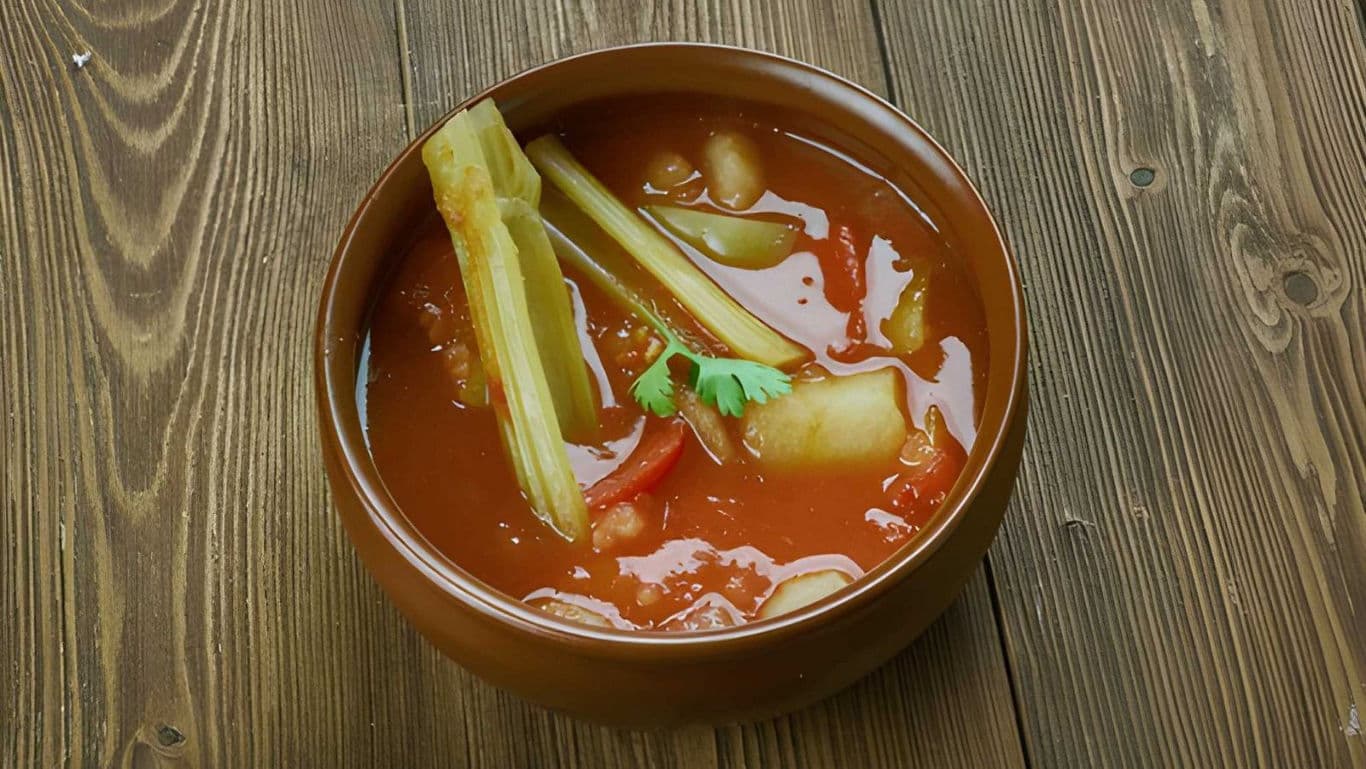 Bowl of vegetable soup on wooden table