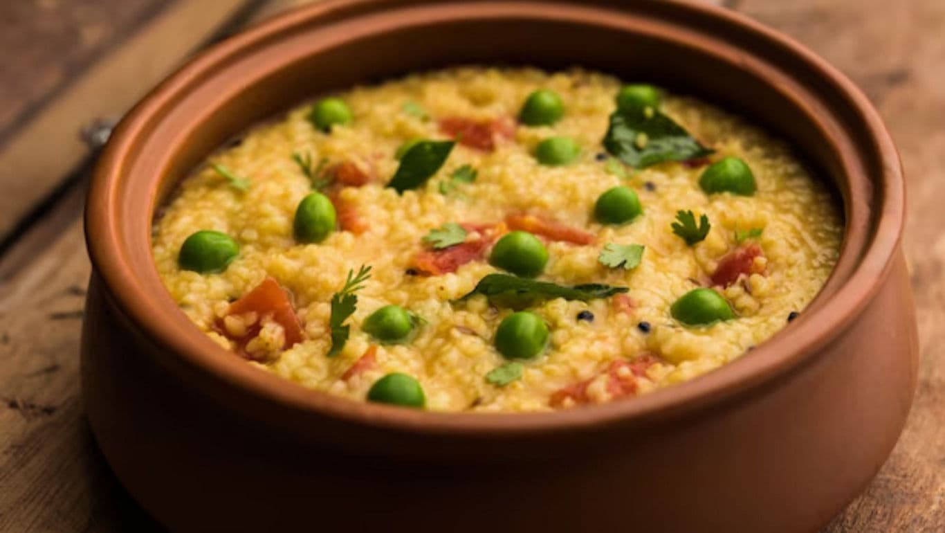 Clay pot with yellow rice and peas