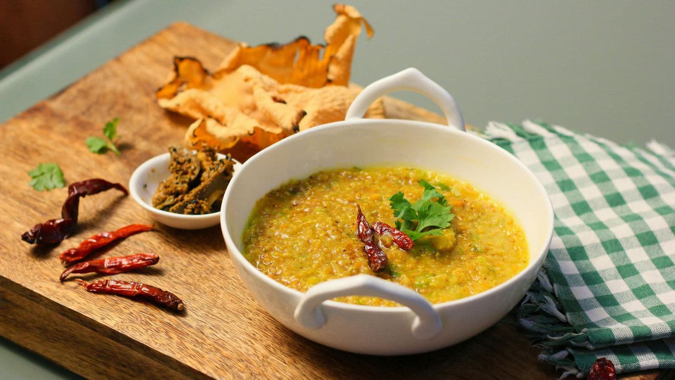Spicy lentil soup with dried chilies and papadum