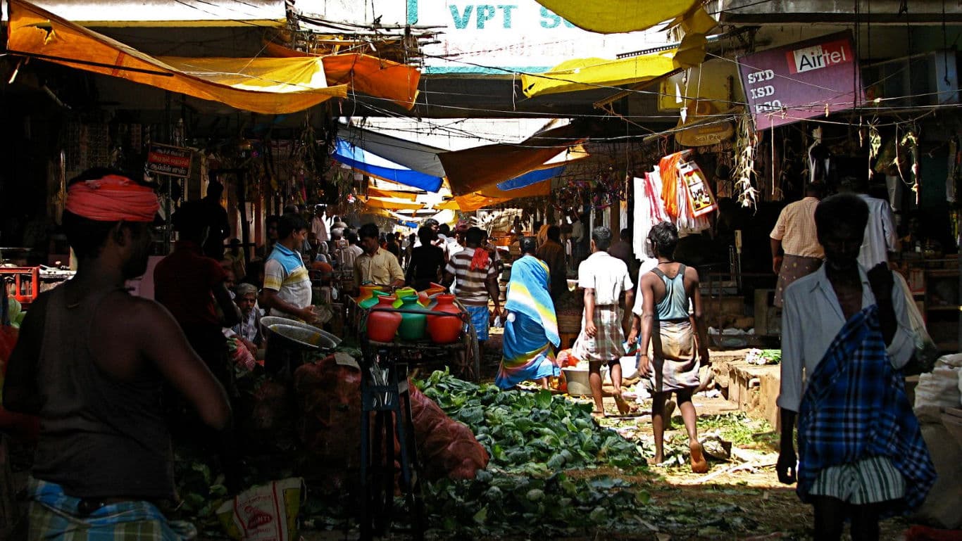 Bustling outdoor vegetable market scene