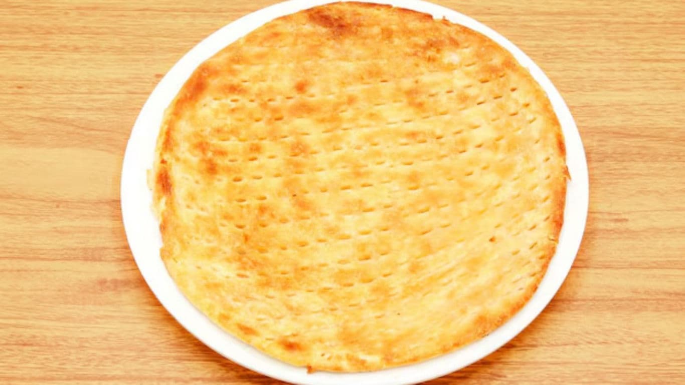 Golden baked flatbread on white plate