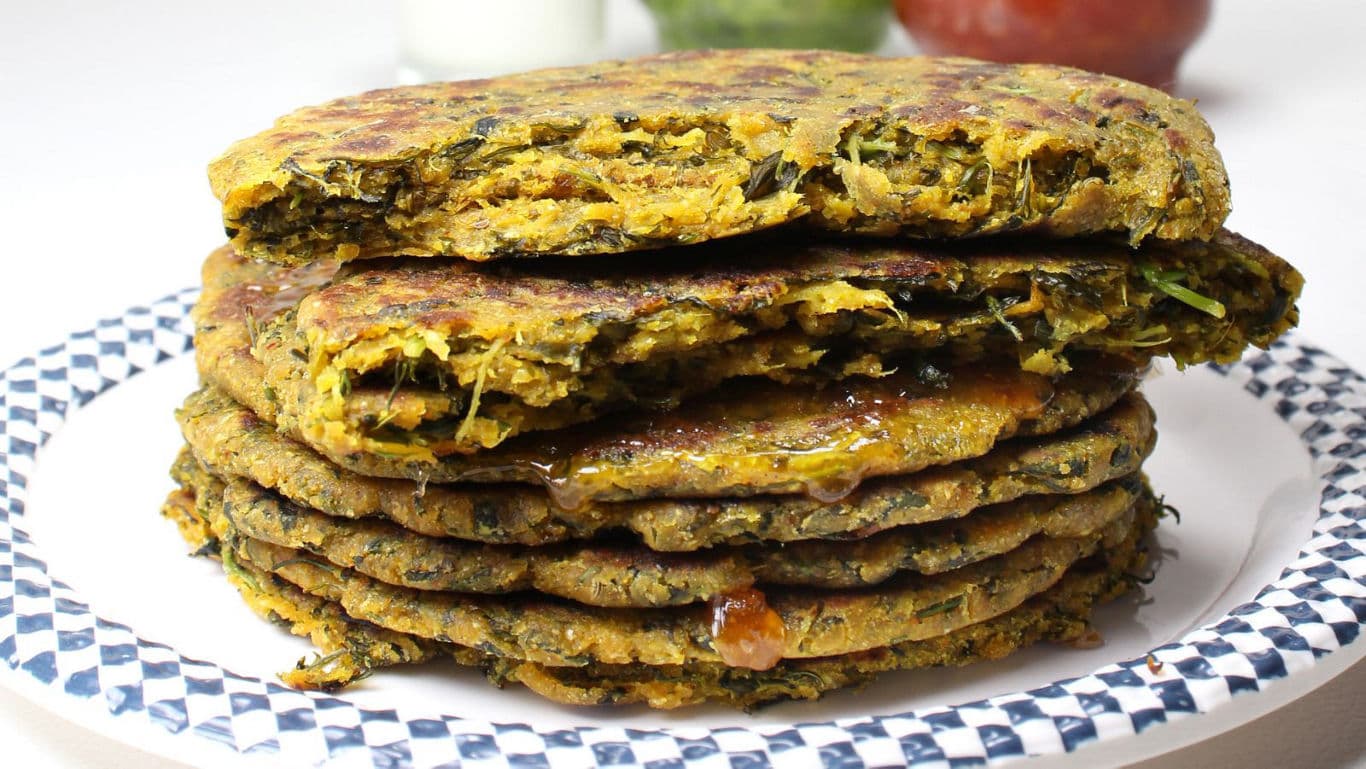 Stack of savory flatbreads with chutney