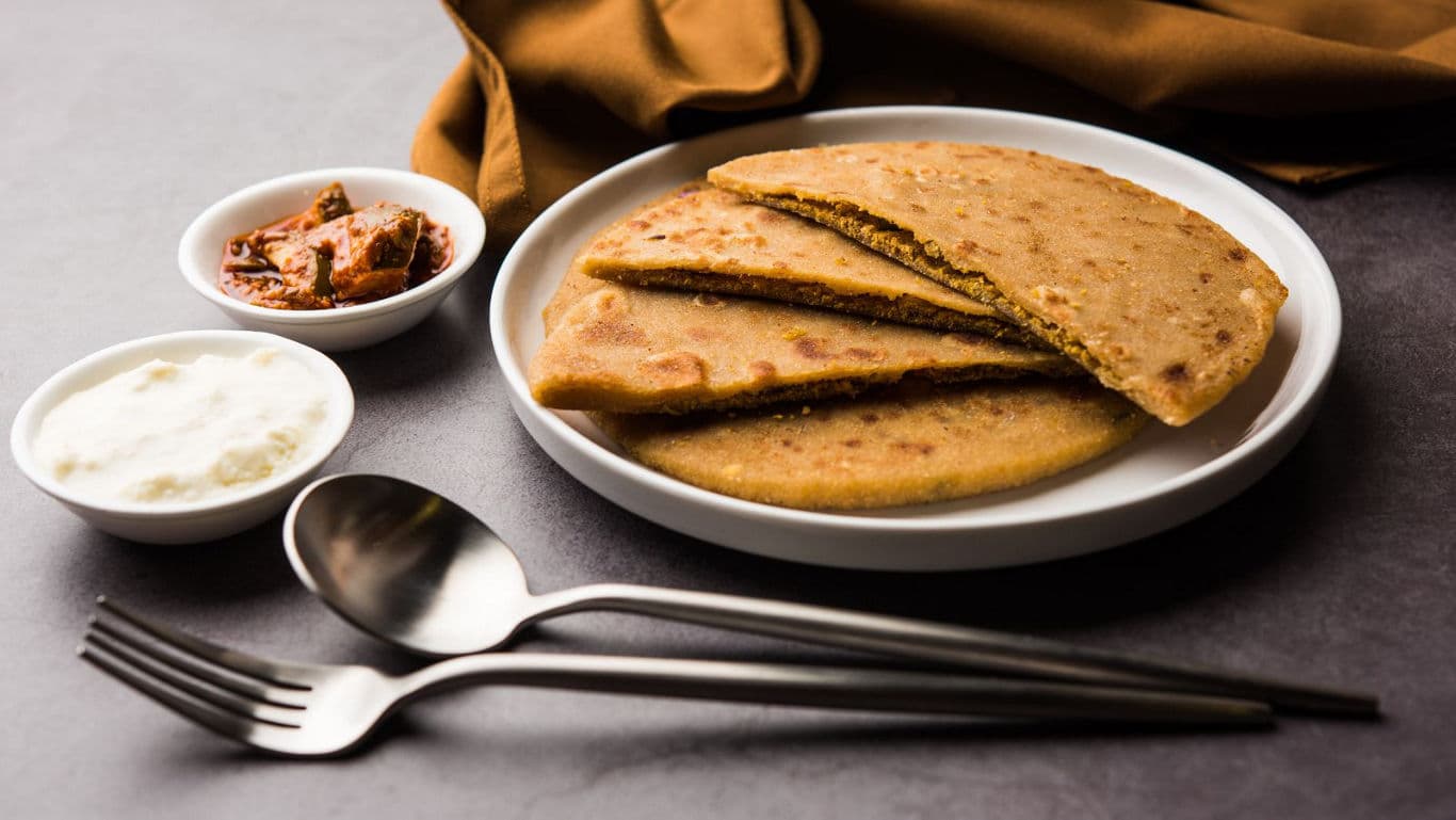 Stuffed paratha with yogurt and pickle