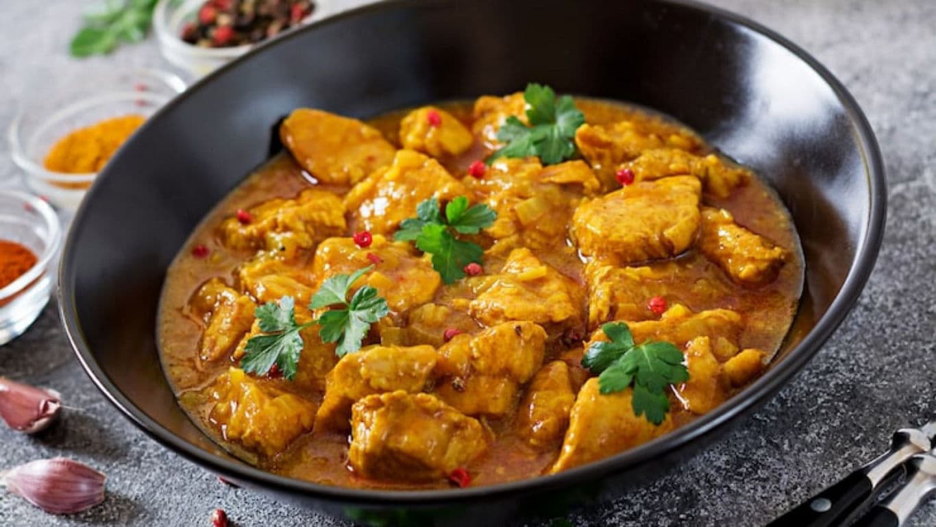 One-pot chicken korma for dinner with chopped coriander