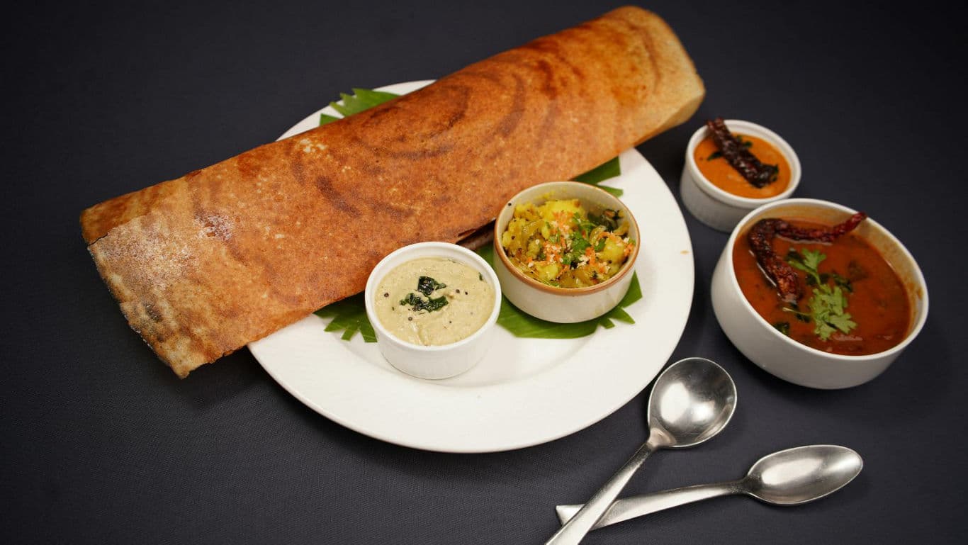South Indian breakfast plate with dosa, sambar, and chutney