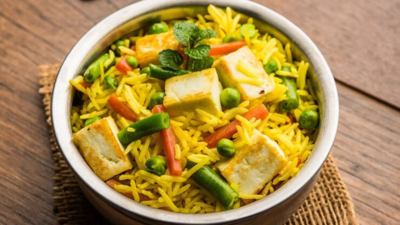 Paneer pulao close-up with a mint sprig on it
