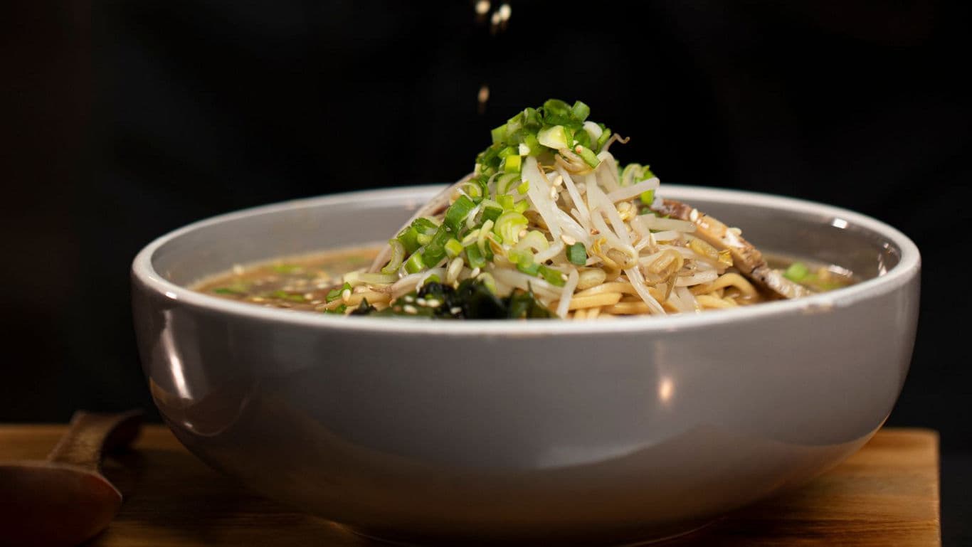 Japanese ramen noodles being topped