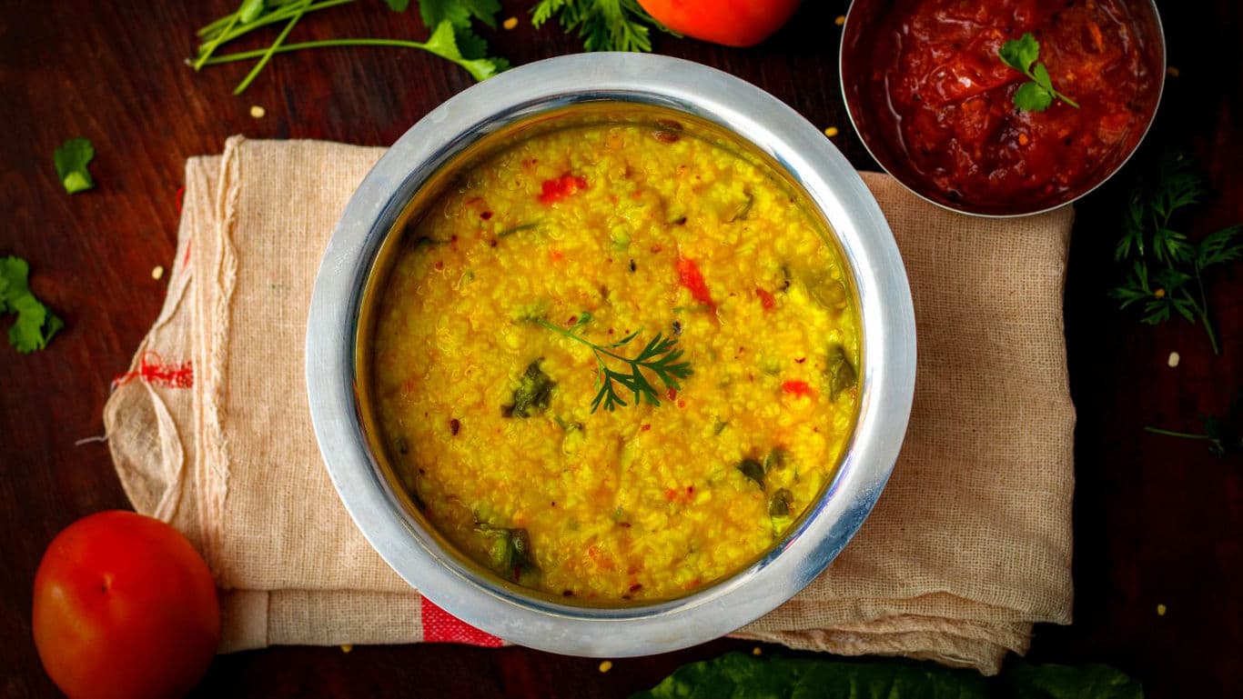 Khichdi in a bowl with condiments