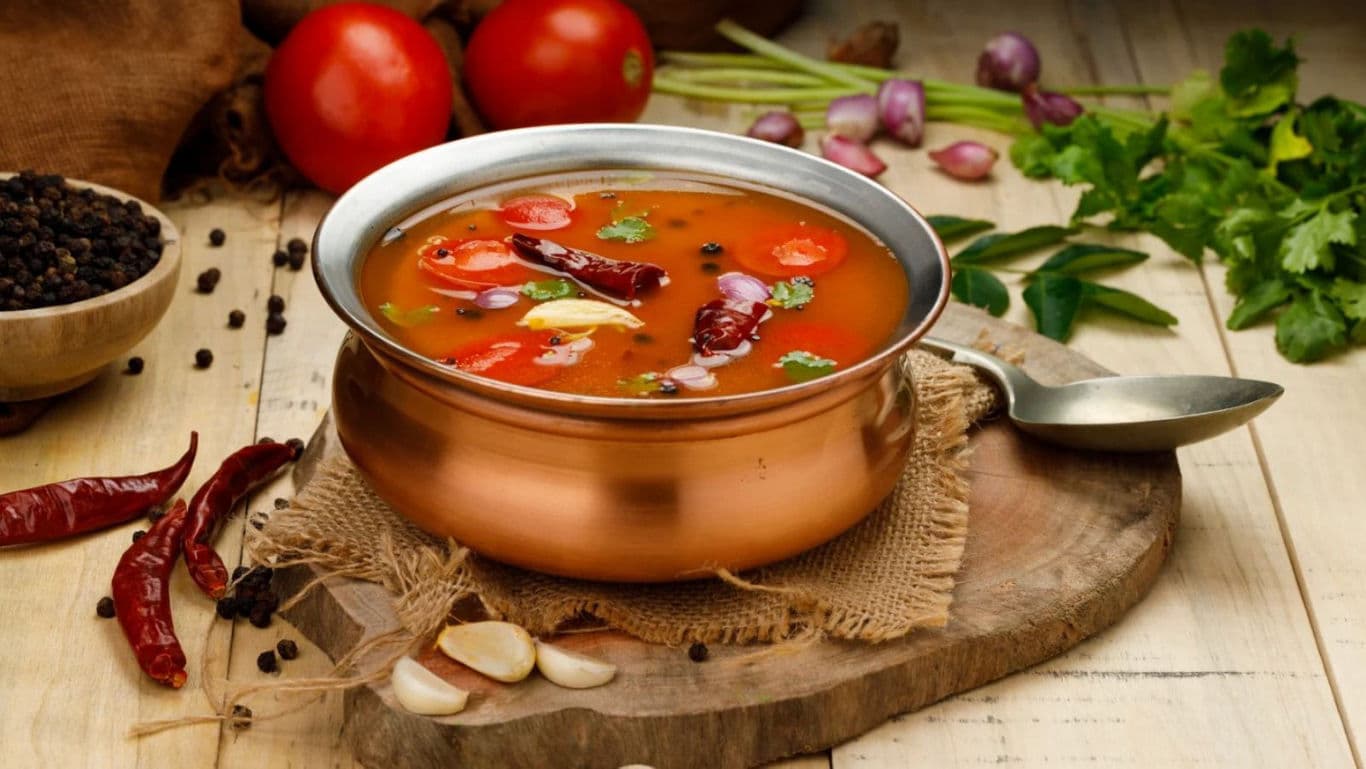 Rasam in a bowl with chilli and garlic