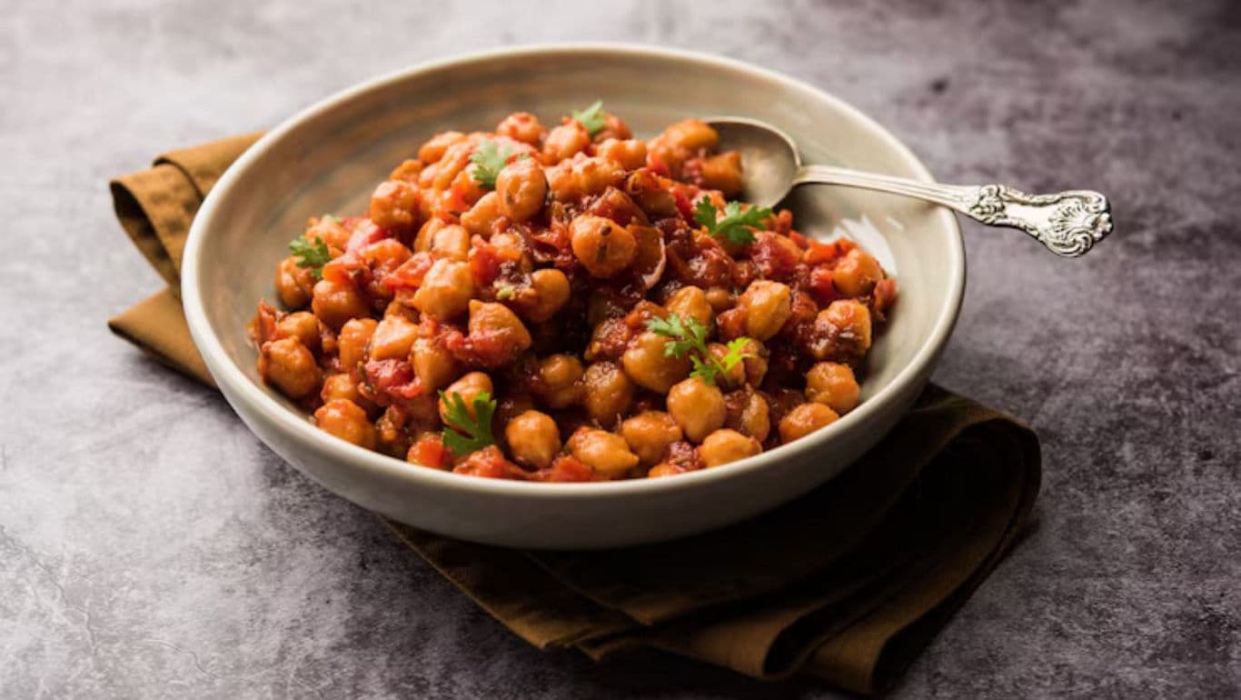 Chickpea stew with tomatoes and herbs in bowl