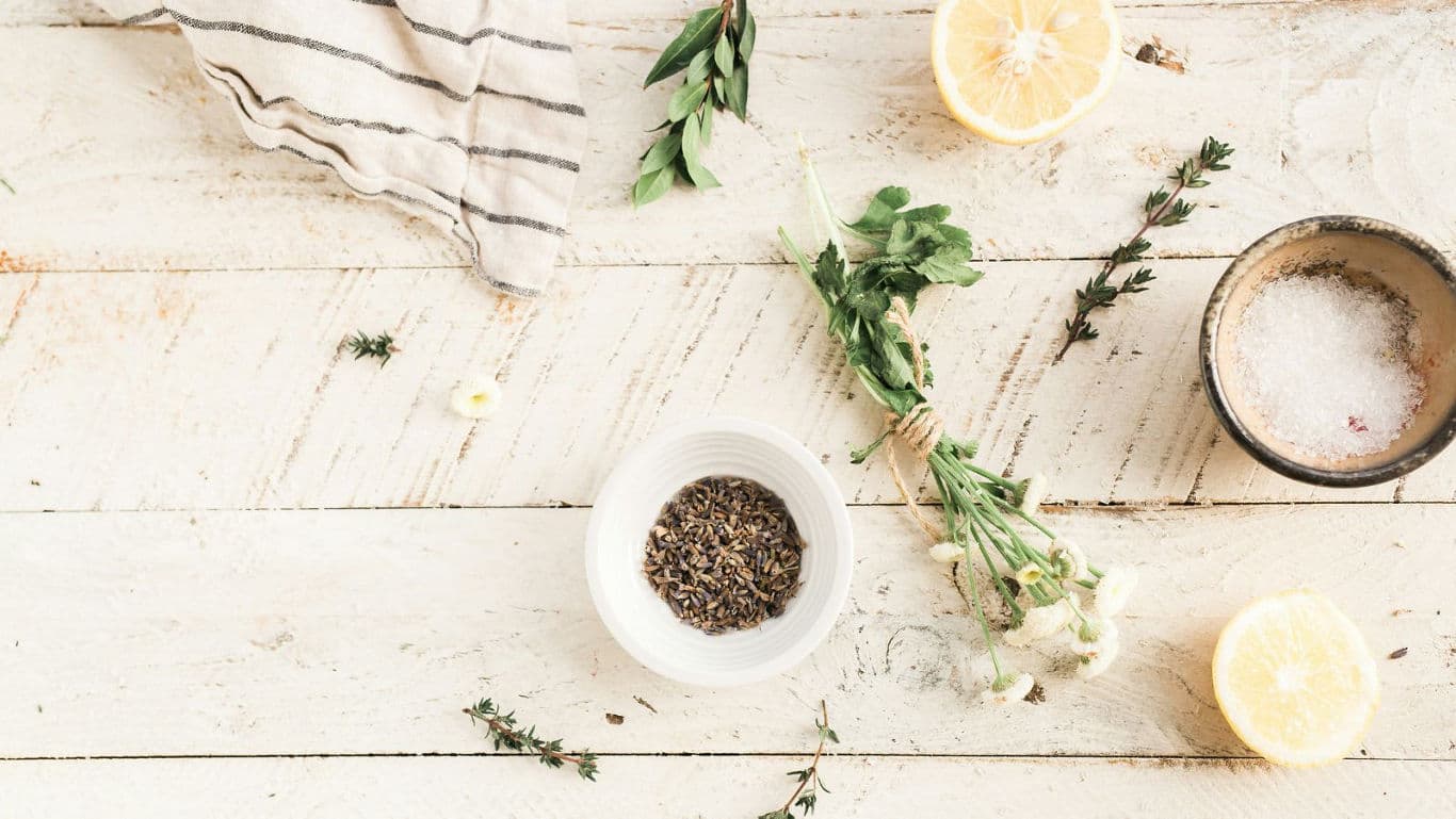 Herbs, spices, and lemons on rustic table