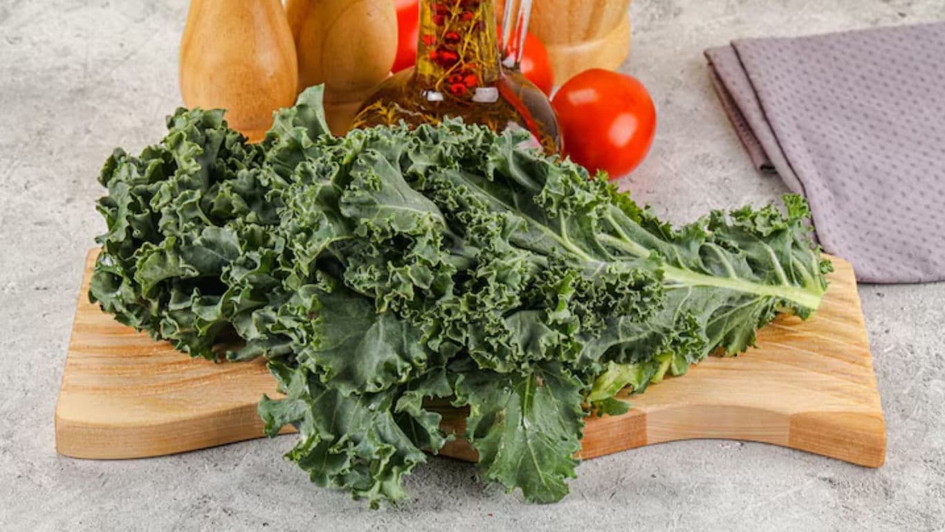 Fresh kale leaves on wooden cutting board