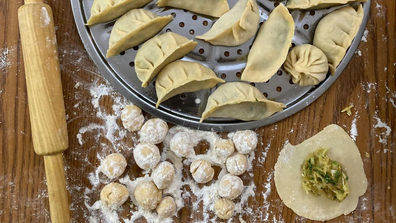 Homemade dumplings with rolling pin and steamer