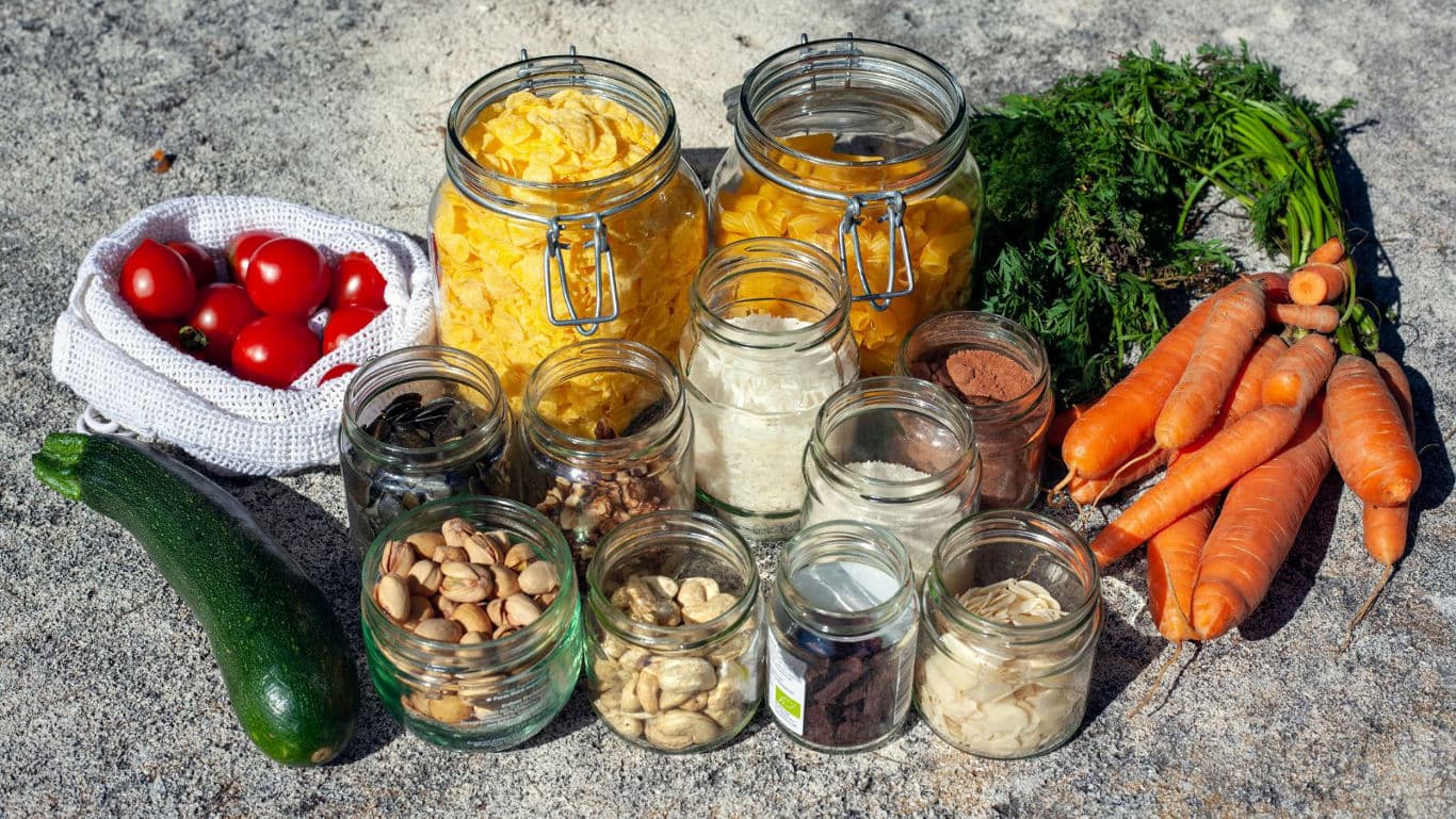 Assorted Fresh Vegetables and Pantry Items in Jars