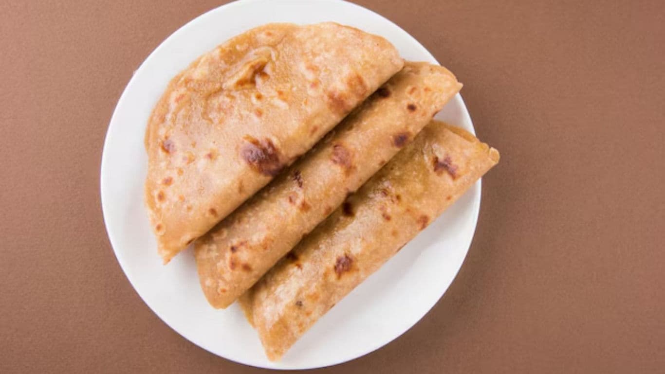 Three folded flatbreads on white plate